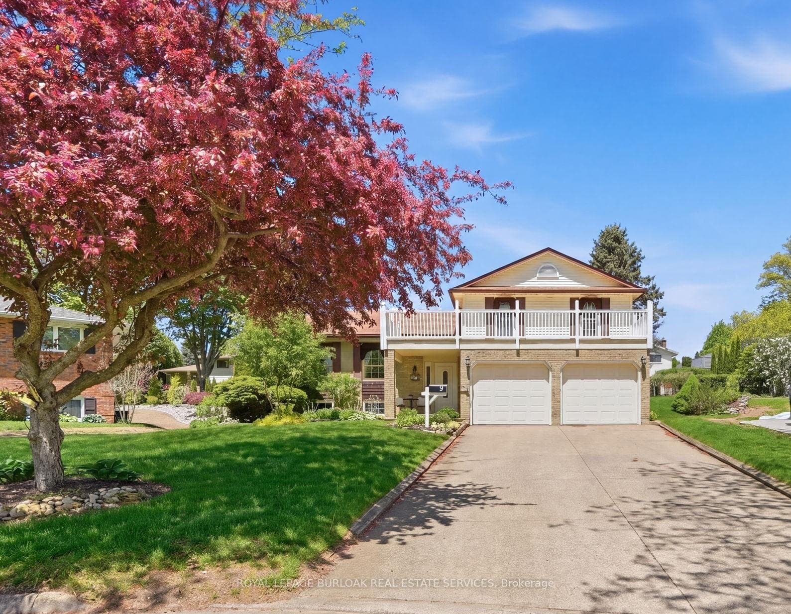 Front of house, located on a beautiful court.