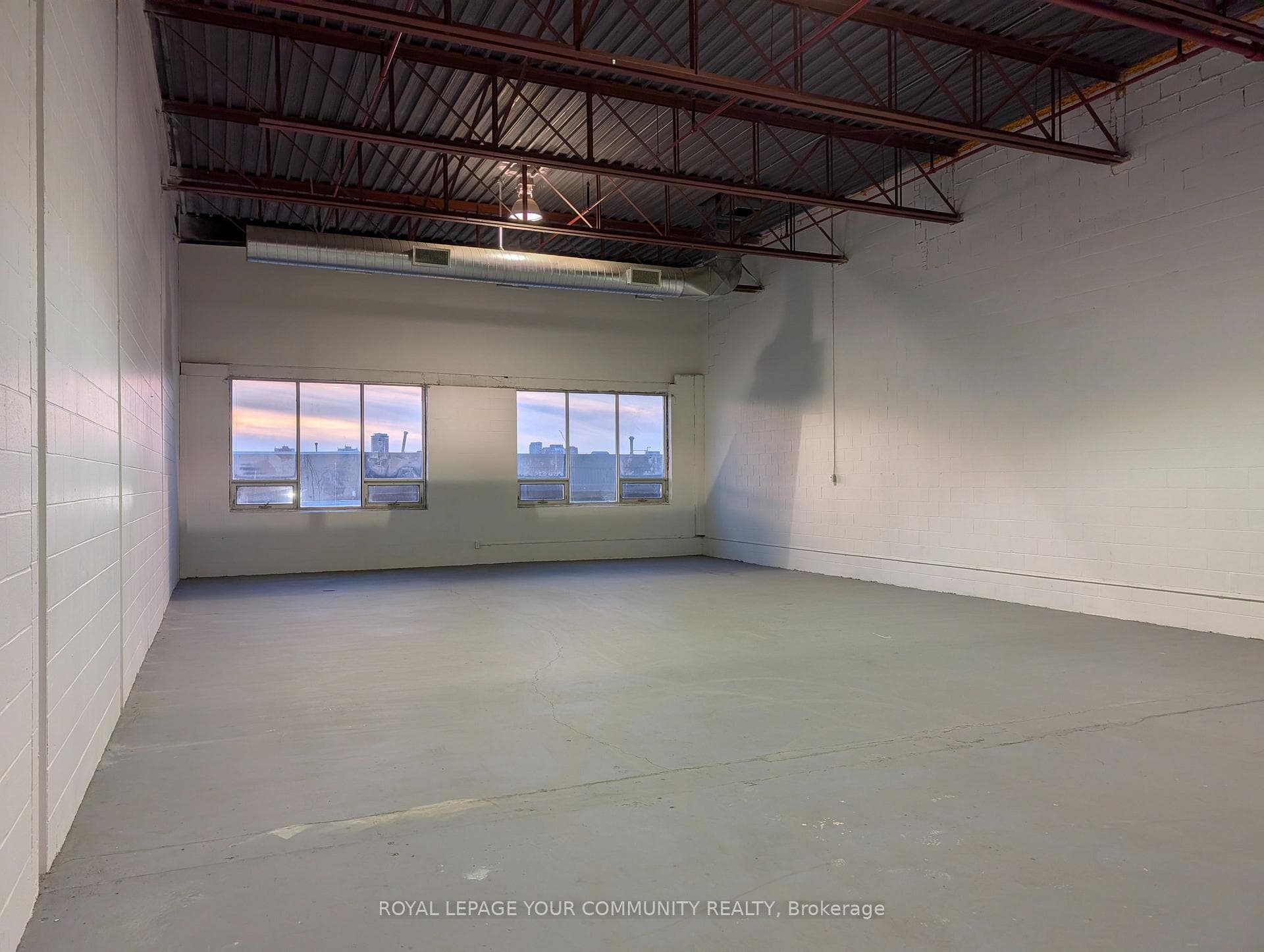 west side of space showing large windows and HVAC