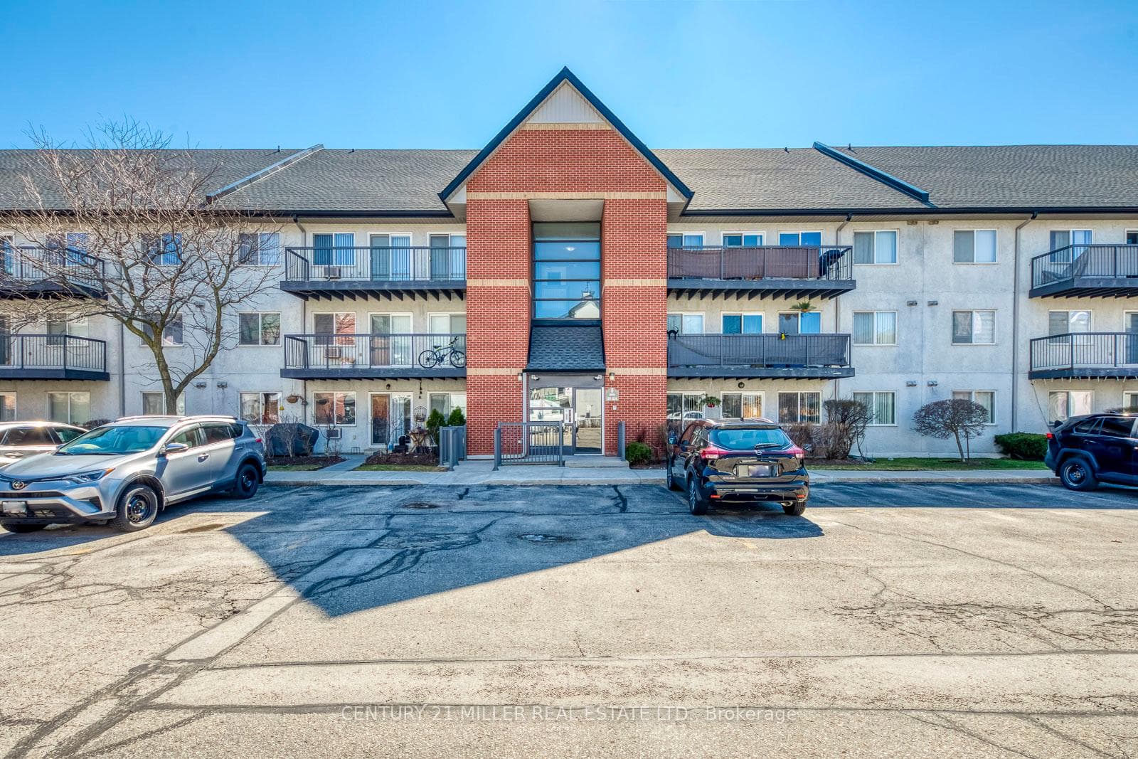 Front View Of Low-Rise Building With Parking