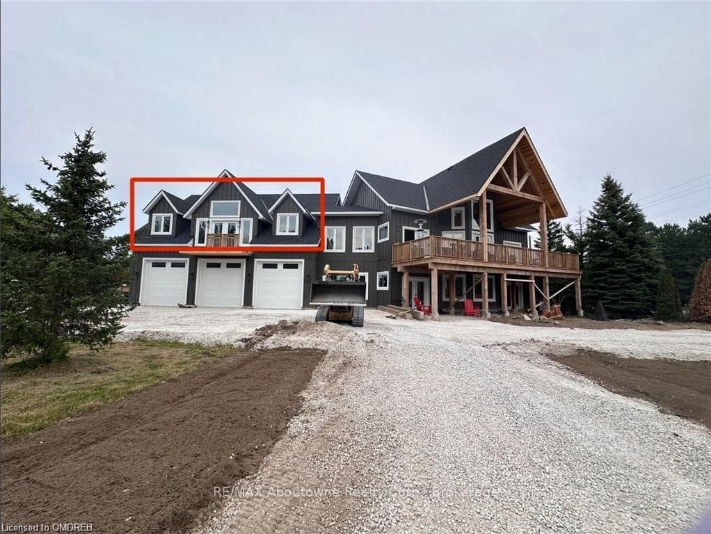 View of front of house with a garage and a deck