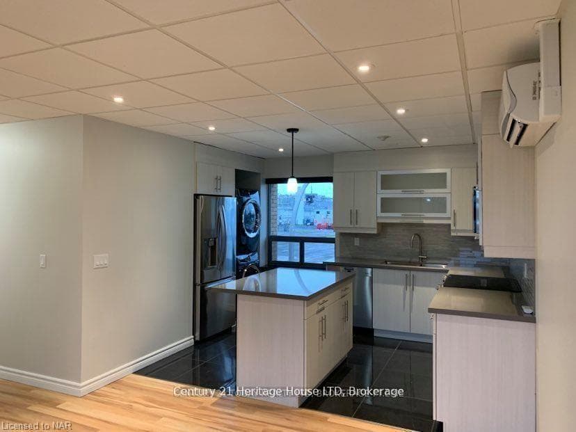 Kitchen with washer and dryer in unit