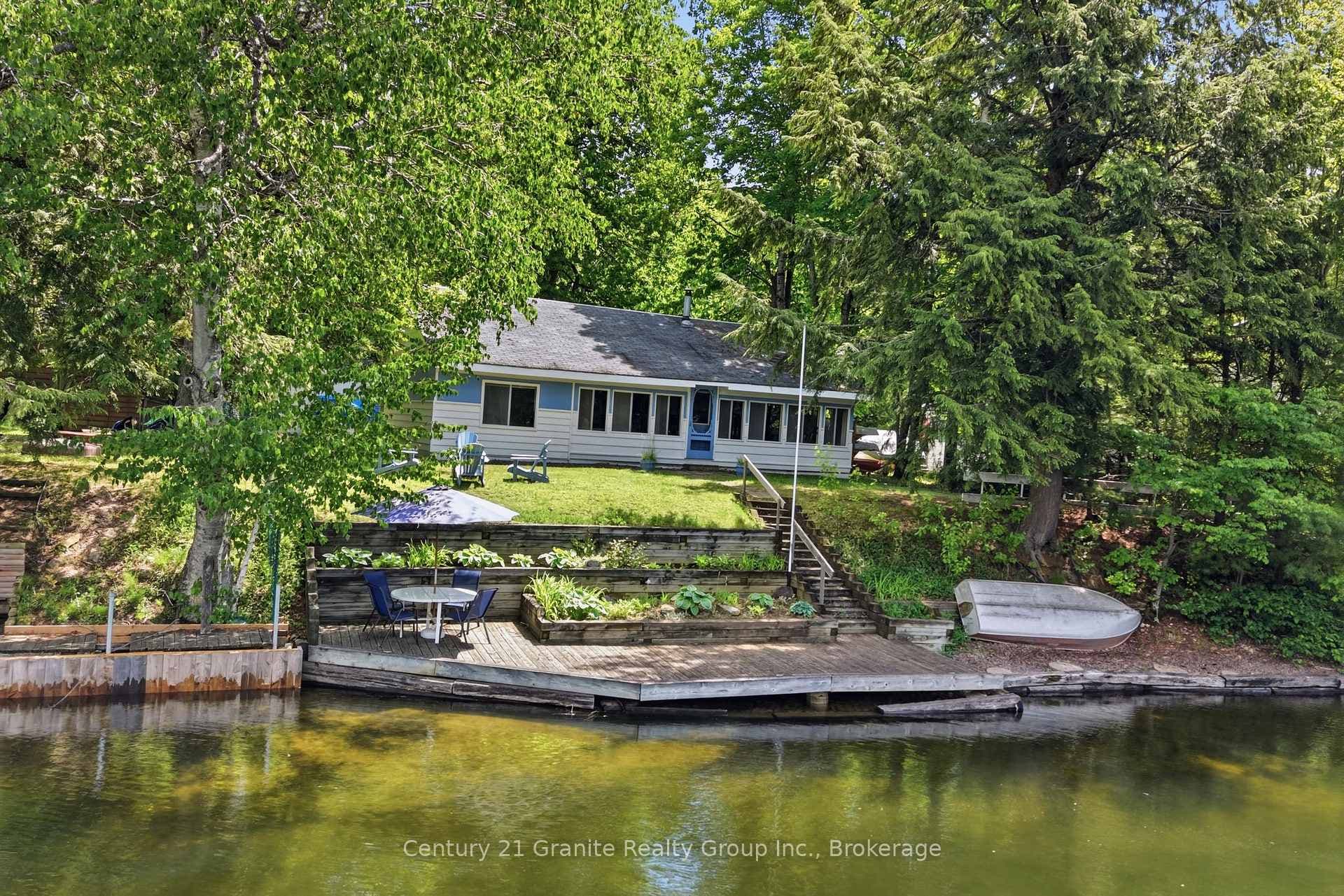 VIEW OF BACK OF COTTAGE FROM THE RIVER