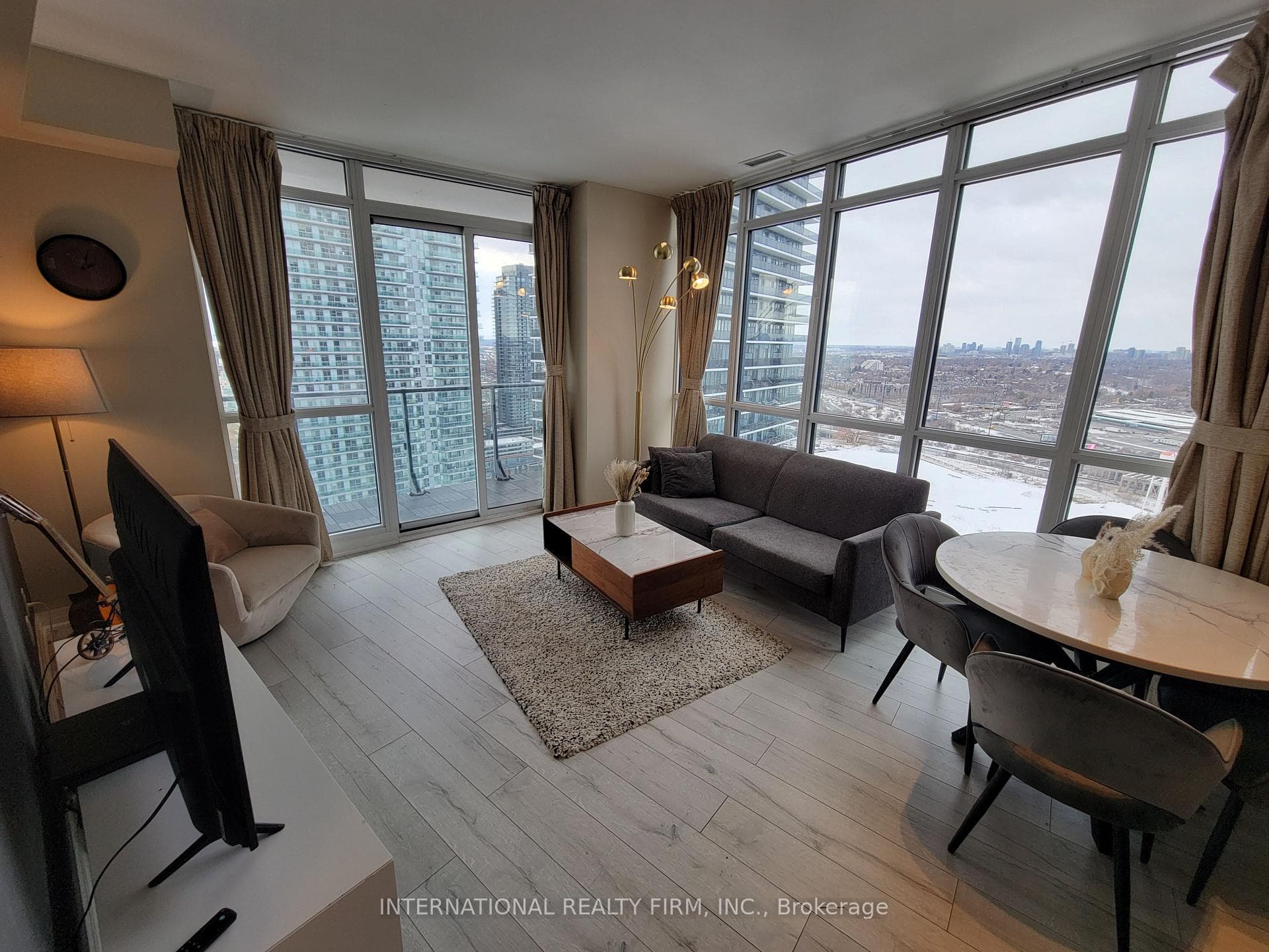 Panoramic living/dining, floor-to-ceiling views
